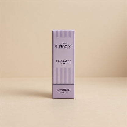 Packaged Hideaway Home Fragrances lavender fields fragrance oil bottle standing beside its luxury retail box highlighting pure calming lavender aromas.