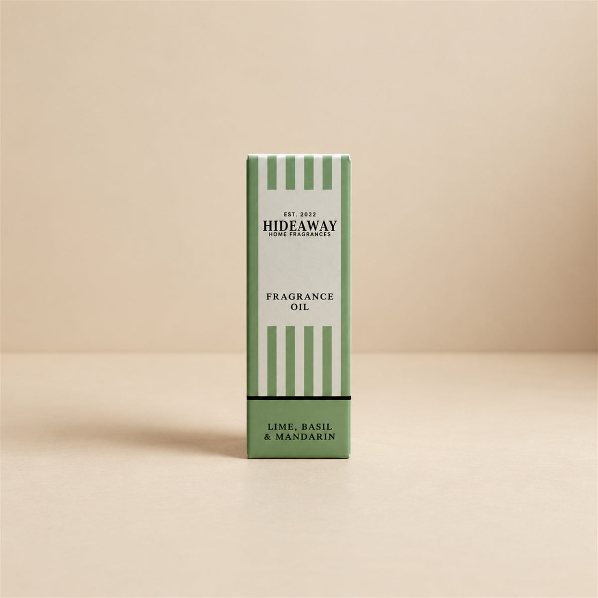 Packaged Hideaway Home Fragrances lime basil and mandarin fragrance oil bottle standing beside its luxury retail box highlighting lime, spearmint, and vetiver notes.