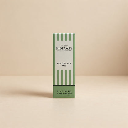 Packaged Hideaway Home Fragrances lime basil and mandarin fragrance oil bottle standing beside its luxury retail box highlighting lime, spearmint, and vetiver notes.