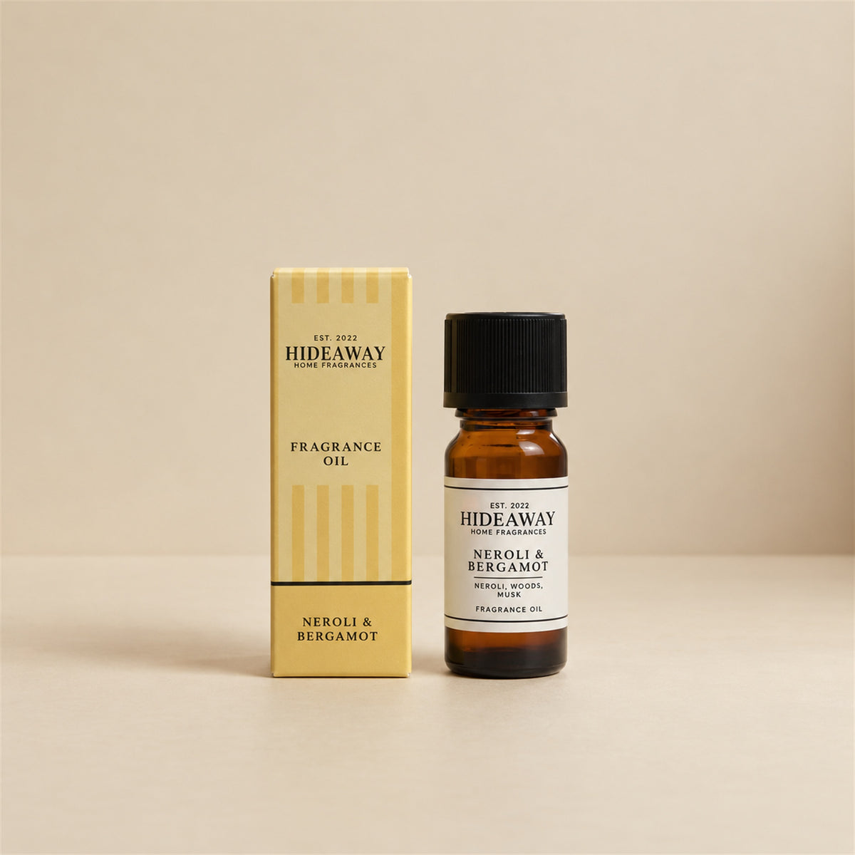 Hideaway Home Fragrances neroli and bergamot fragrance oil bottle standing against a seamless neutral studio backdrop.