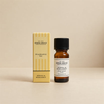 Hideaway Home Fragrances neroli and bergamot fragrance oil bottle standing against a seamless neutral studio backdrop.