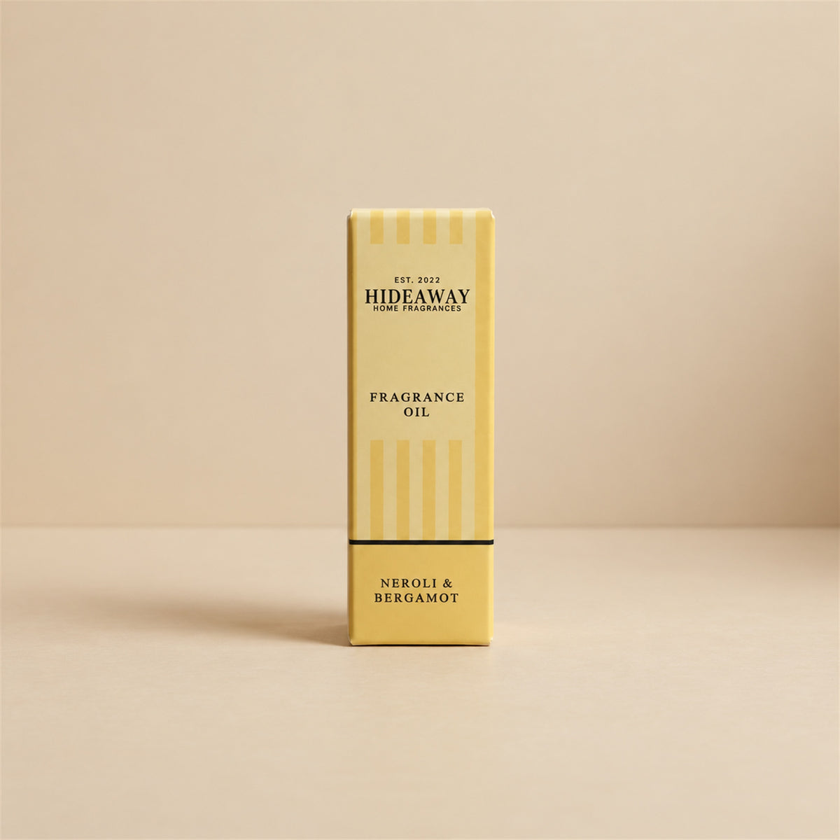 Packaged Hideaway Home Fragrances neroli and bergamot fragrance oil bottle standing beside its luxury retail box highlighting mandarin, cedarwood, and patchouli notes.