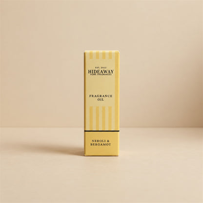 Packaged Hideaway Home Fragrances neroli and bergamot fragrance oil bottle standing beside its luxury retail box highlighting mandarin, cedarwood, and patchouli notes.