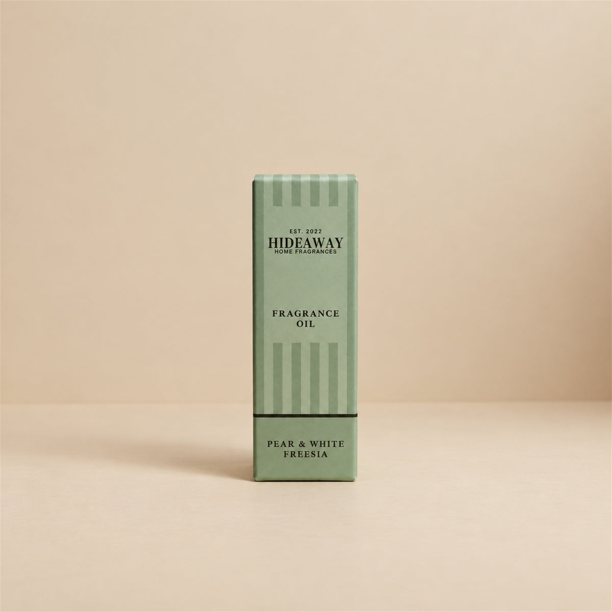 Packaged Hideaway Home Fragrances pear and white freesia fragrance oil bottle shown beside its luxury gift box highlighting delicate melon, rose, and patchouli notes.