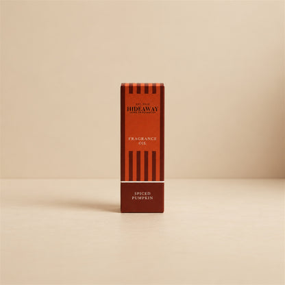 Packaged Hideaway Home Fragrances spiced pumpkin fragrance oil bottle standing beside its luxury retail box highlighting cozy autumn spice and musk notes.
