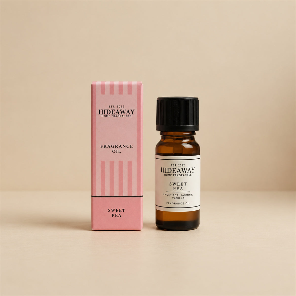 Hideaway Home Fragrances sweet pea fragrance oil bottle standing against a seamless neutral studio backdrop.