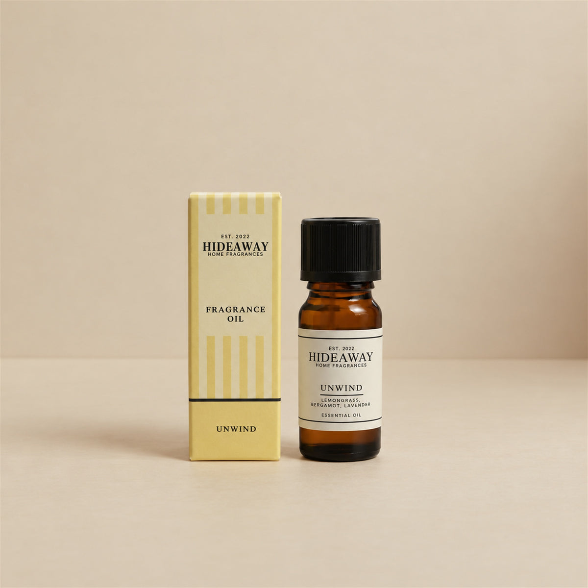 Hideaway Home Fragrances unwind fragrance oil bottle standing against a seamless neutral studio backdrop.