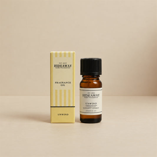 Hideaway Home Fragrances unwind fragrance oil bottle standing against a seamless neutral studio backdrop.
