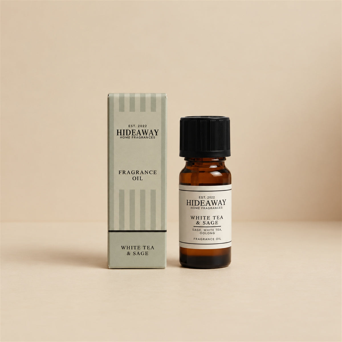 Hideaway Home Fragrances white tea and sage fragrance oil bottle standing against a seamless neutral studio backdrop.