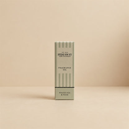 Packaged Hideaway Home Fragrances white tea and sage fragrance oil bottle standing beside its luxury retail box highlighting herbal thyme and soothing tea notes.