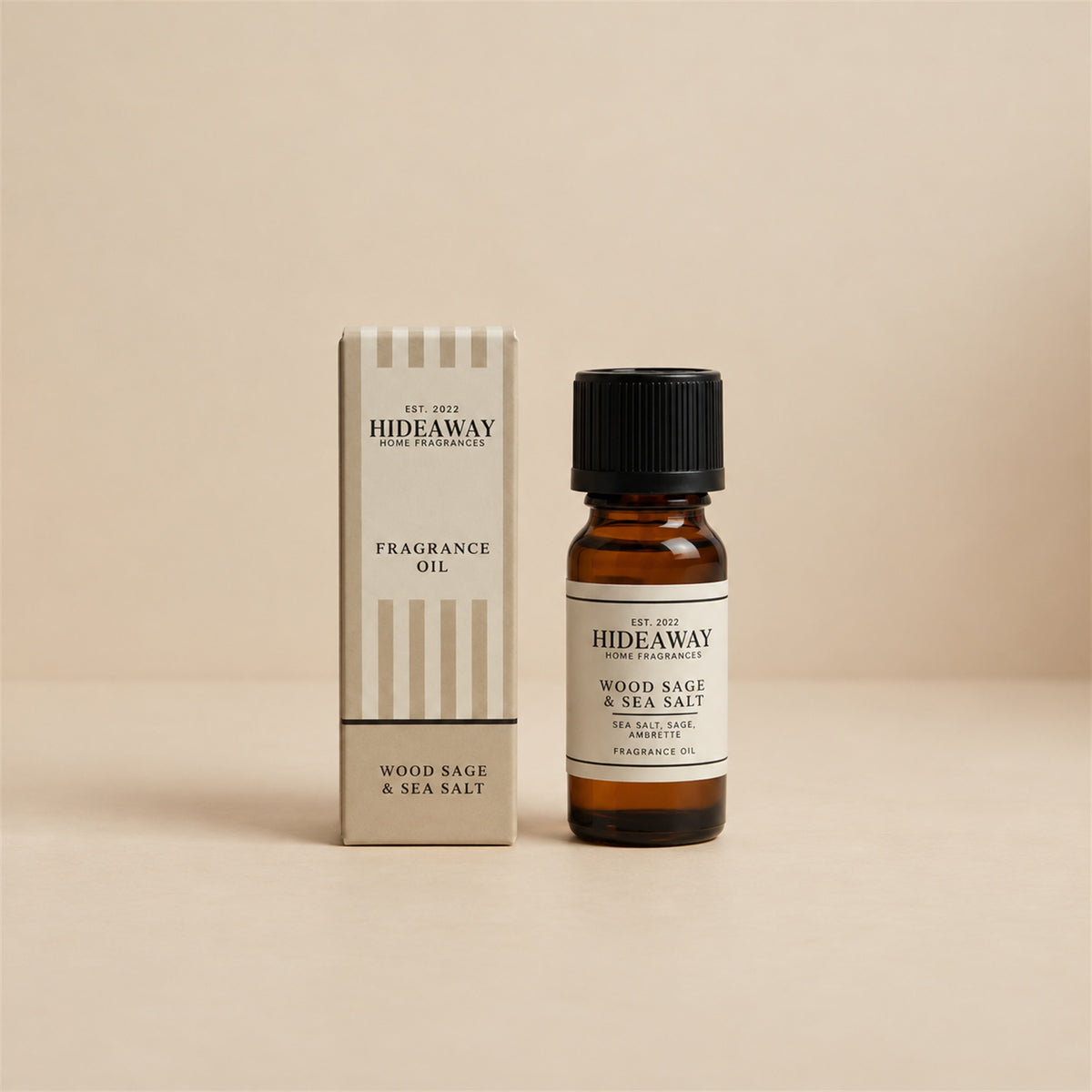Hideaway Home Fragrances wood sage and sea salt fragrance oil bottle standing against a seamless neutral studio backdrop.