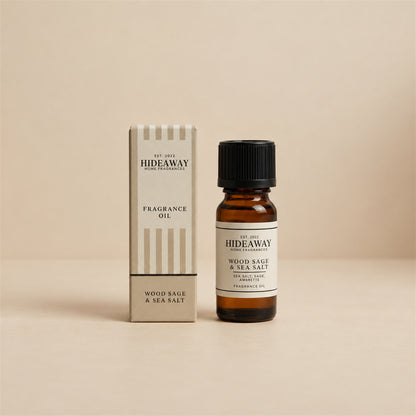 Hideaway Home Fragrances wood sage and sea salt fragrance oil bottle standing against a seamless neutral studio backdrop.