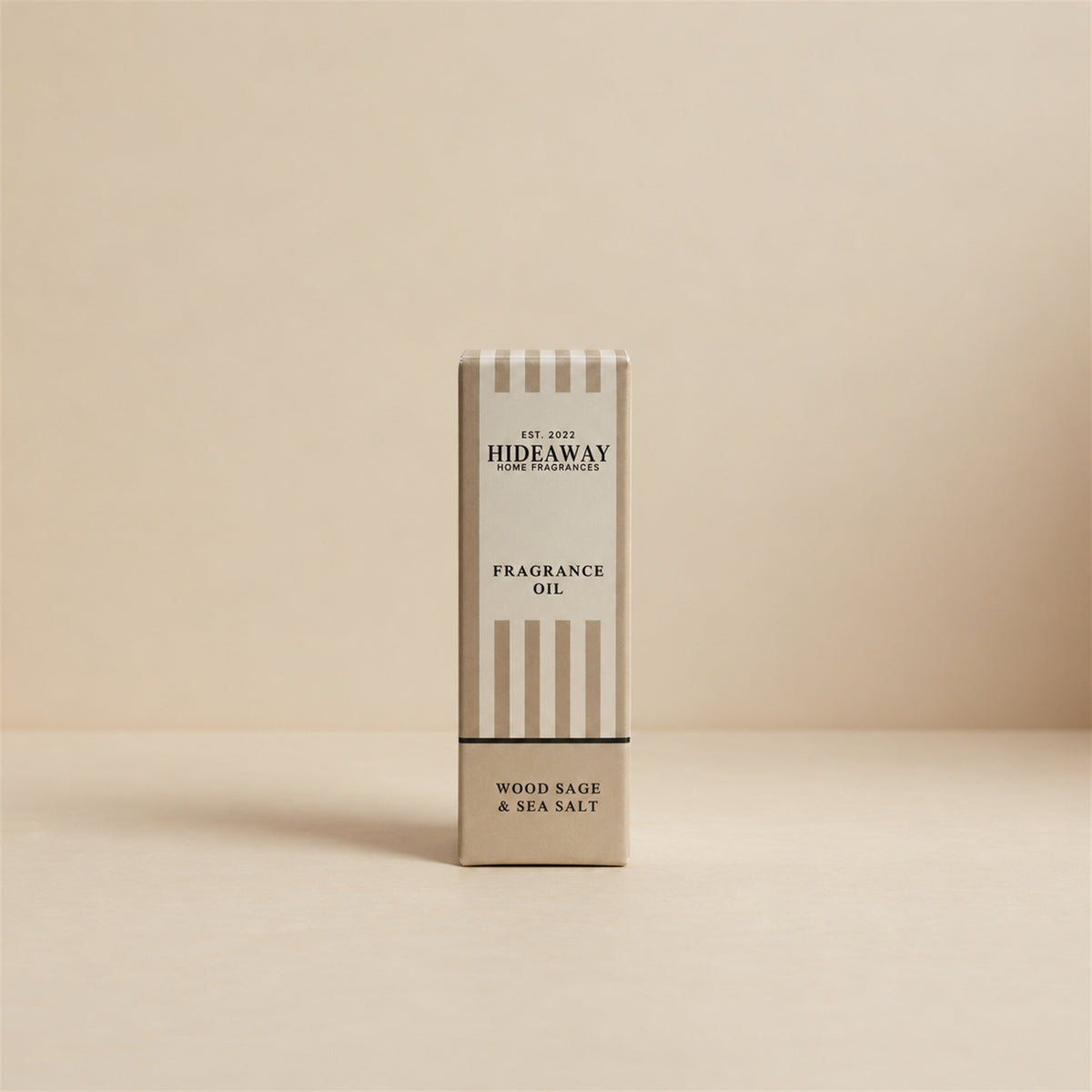 Packaged Hideaway Home Fragrances wood sage and sea salt fragrance oil bottle standing beside its luxury retail box highlighting ambrette seeds, ozone, and cedarwood notes.