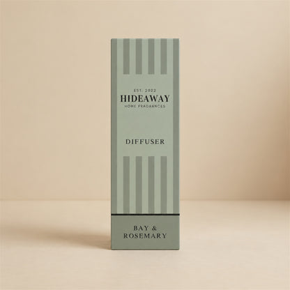 Herbal bay and rosemary reed diffuser with natural reeds on a styled shelf by Hideaway Home Fragrances