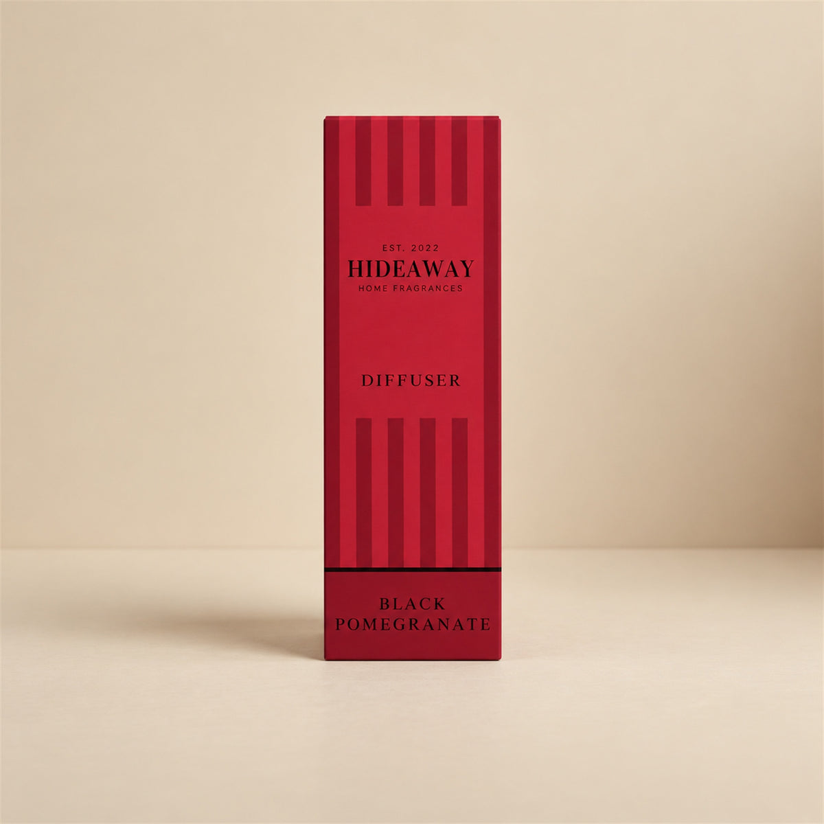 Pouring black pomegranate fragrance oil for a Hideaway Home Fragrances reed diffuser