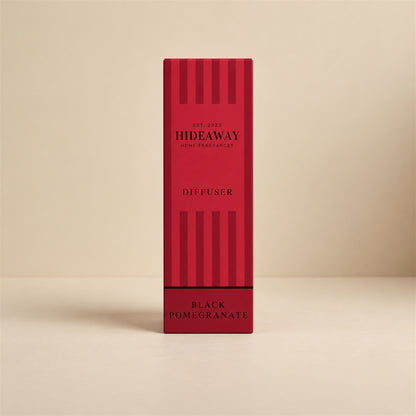Pouring black pomegranate fragrance oil for a Hideaway Home Fragrances reed diffuser