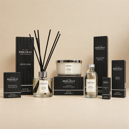 Hideaway Home Fragrances Oud and Bergamot range including 3 wick candles, wax melts, reed diffusers, fragrance oil, and room spray