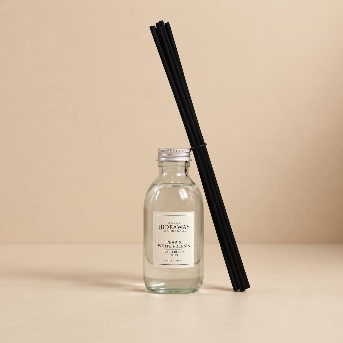 Pouring pear and white freesia fragrance oil refill for a Hideaway Home Fragrances reed diffuser top-up