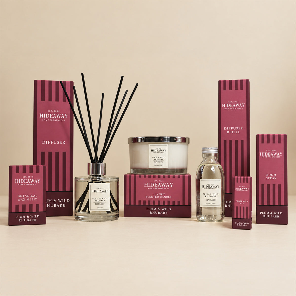 Hideaway Home Fragrances Plum and Wild Rhubarb range including 3 wick candles, wax melts, reed diffusers, fragrance oil, and room spray