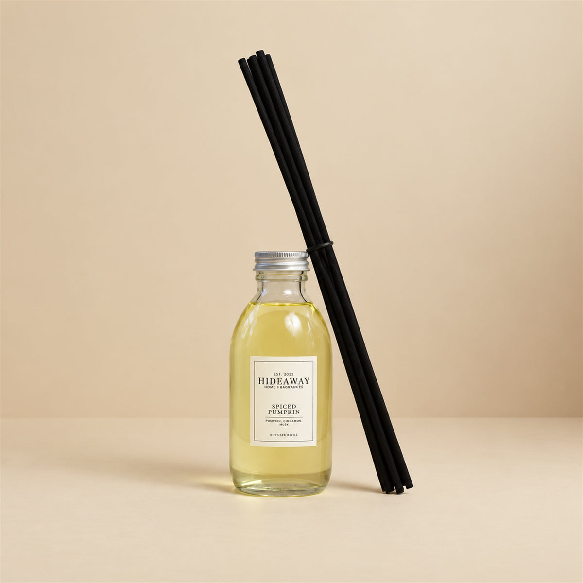 Pouring spiced pumpkin fragrance oil refill for a Hideaway Home Fragrances reed diffuser top-up