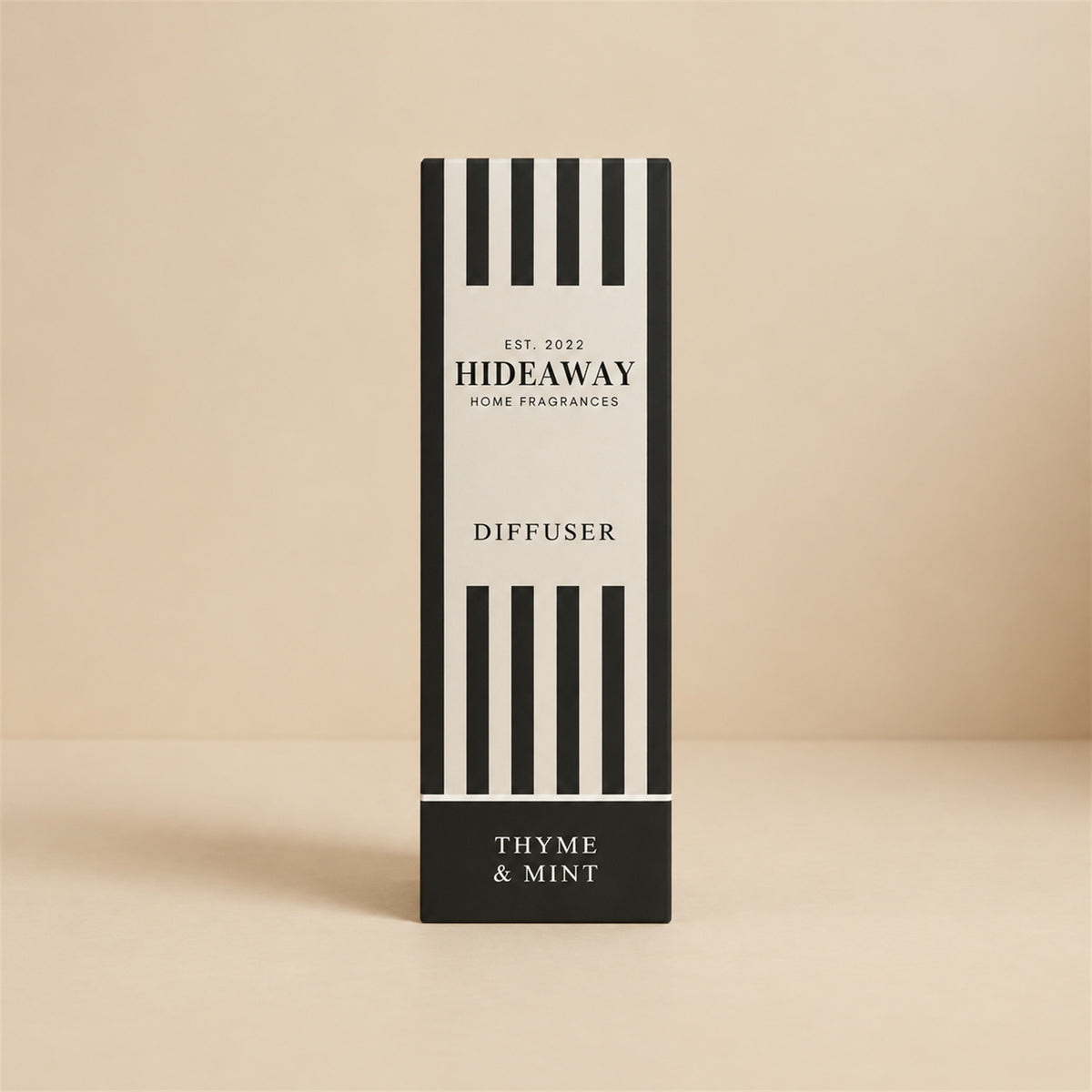 Hideaway Home Fragrances thyme and mint reed diffuser bottle with natural reeds on a kitchen windowsill