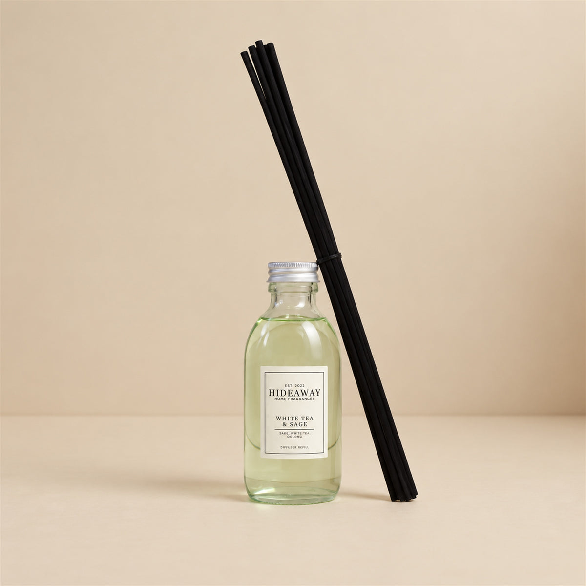 Pouring white tea and sage fragrance oil refill for a Hideaway Home Fragrances reed diffuser top-up
