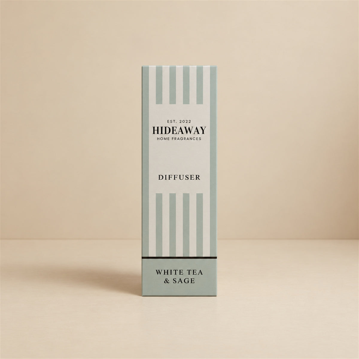Hideaway Home Fragrances white tea and sage reed diffuser bottle with natural reeds on a shelf