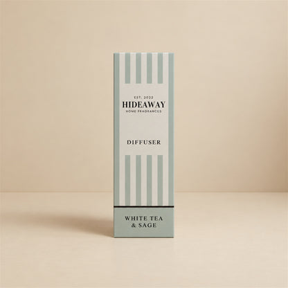 Hideaway Home Fragrances white tea and sage reed diffuser bottle with natural reeds on a shelf