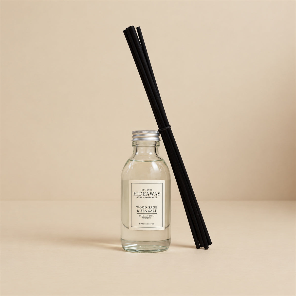 Pouring wood sage and sea salt fragrance oil refill for a Hideaway Home Fragrances reed diffuser top-up