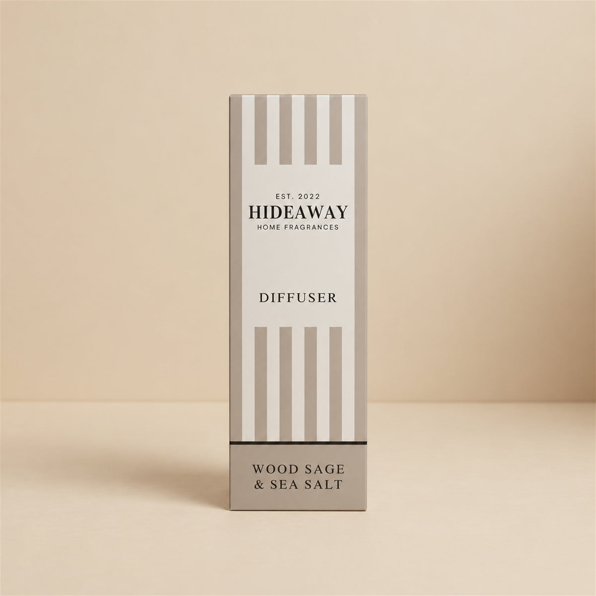 Hideaway Home Fragrances wood sage and sea salt reed diffuser bottle with natural reeds on a console table