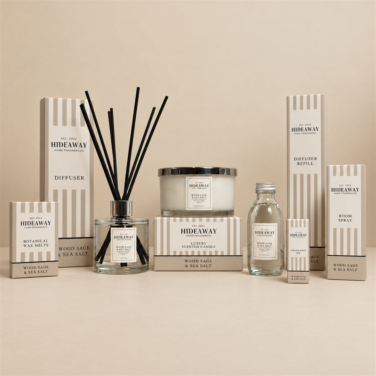 Hideaway Home Fragrances Wood Sage and Sea Salt 3 wick candle burning on a wooden bedside table in a coastal-themed bedroom