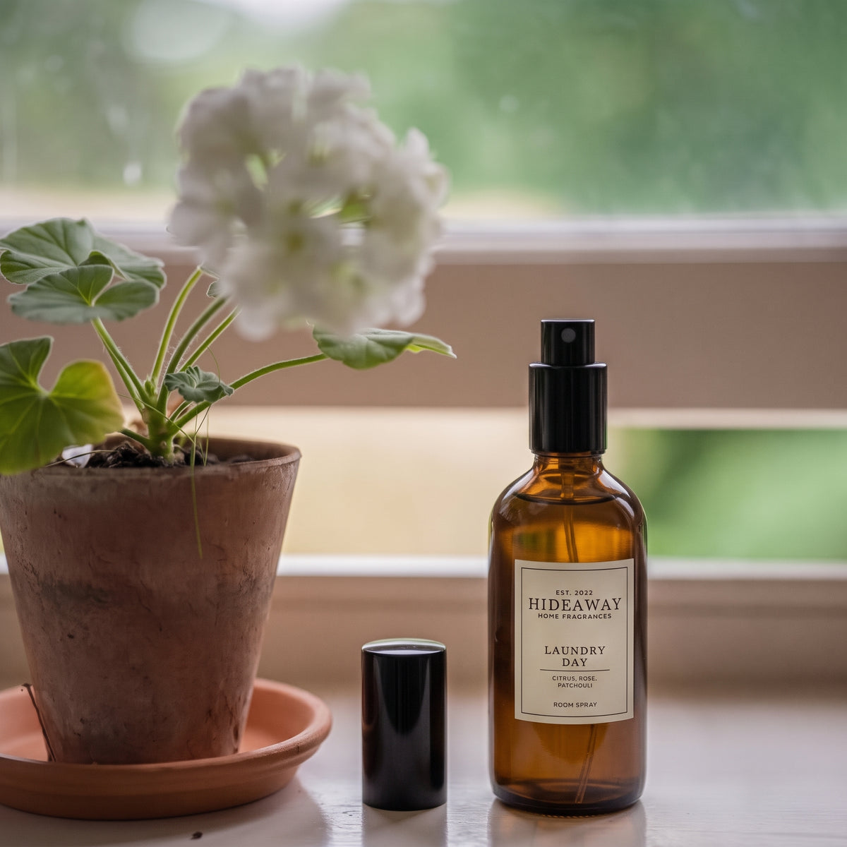 Visual fragrance notes breakdown for Hideaway Home Fragrances laundry day room spray featuring orange, green apple, rose, and patchouli.