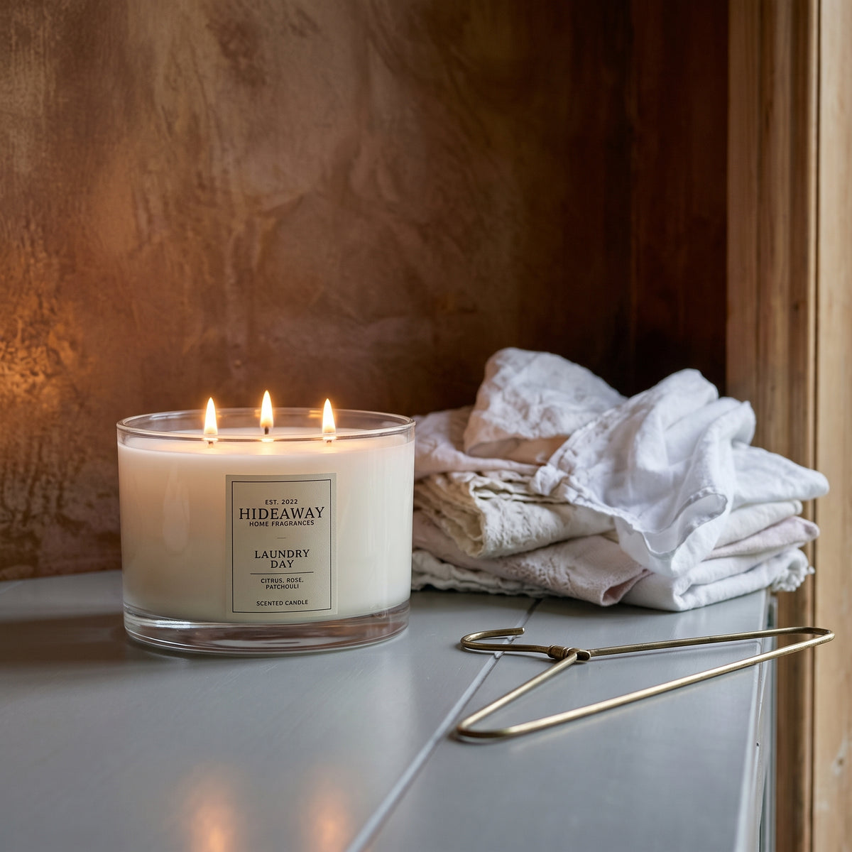 Laundry Day 3-wick candle filling a bright living room with fresh linen fragrance for a clean, airy home atmosphere
