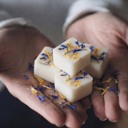 Close up of Hideaway Home Fragrances wood sage and sea salt botanical wax melts showing textured soy wax embedded with natural botanicals