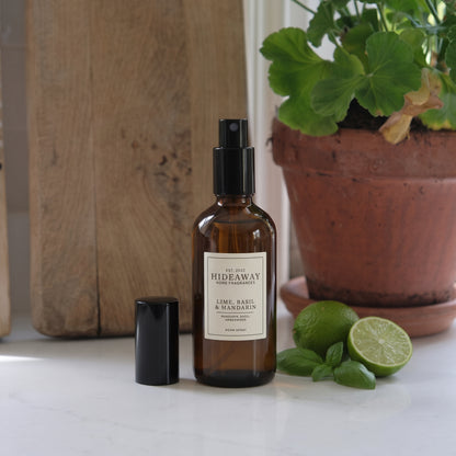 Scent notes graphic for Hideaway Home Fragrances lime basil and mandarin room spray featuring zesty lemon, herbal spearmint, thyme, and amberwood.