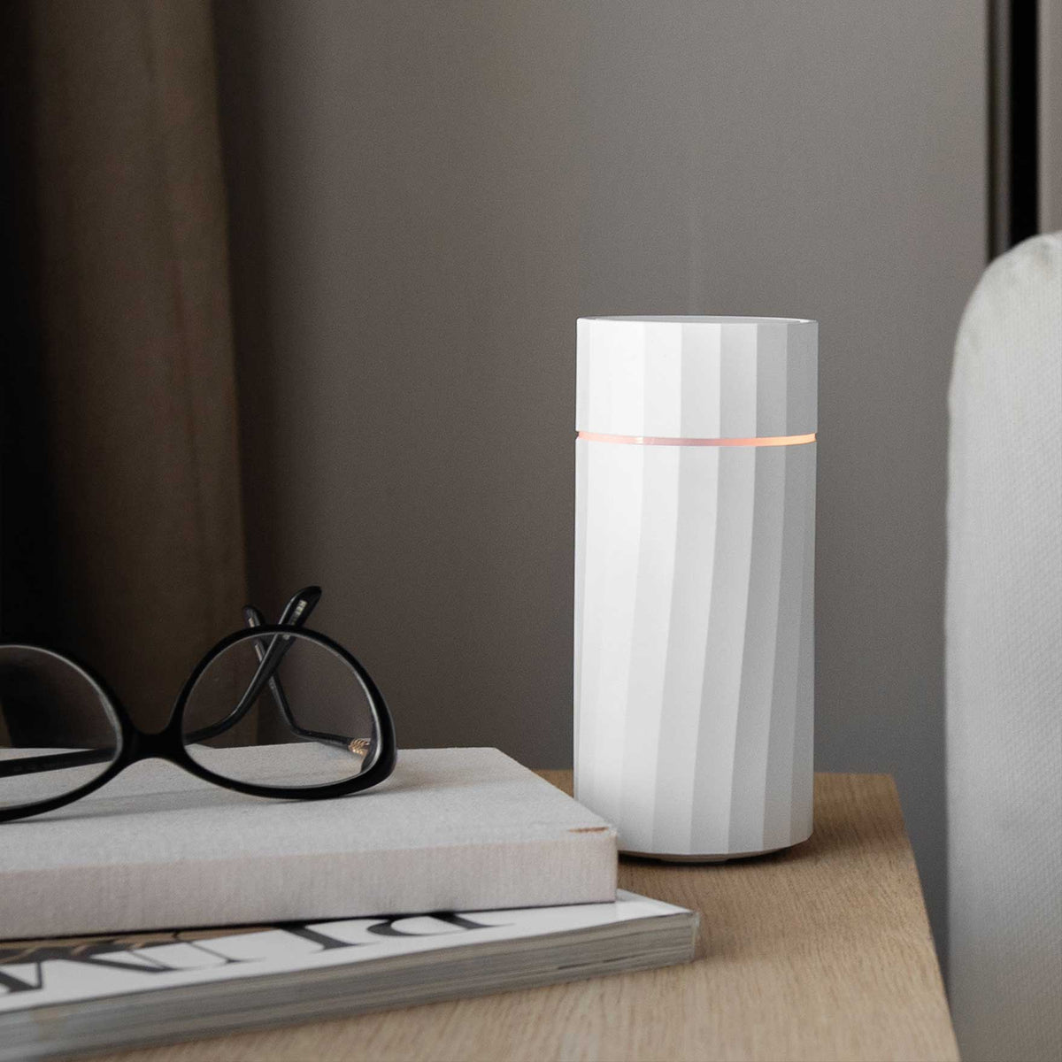 Nomad Rechargeable Wireless Aroma Diffuser in sleek minimalist finish by Hideaway Home Fragrances on neutral studio background