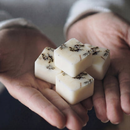 Close up of Hideaway Home Fragrances thyme and mint botanical wax melts showing textured soy wax embedded with natural dried herbs