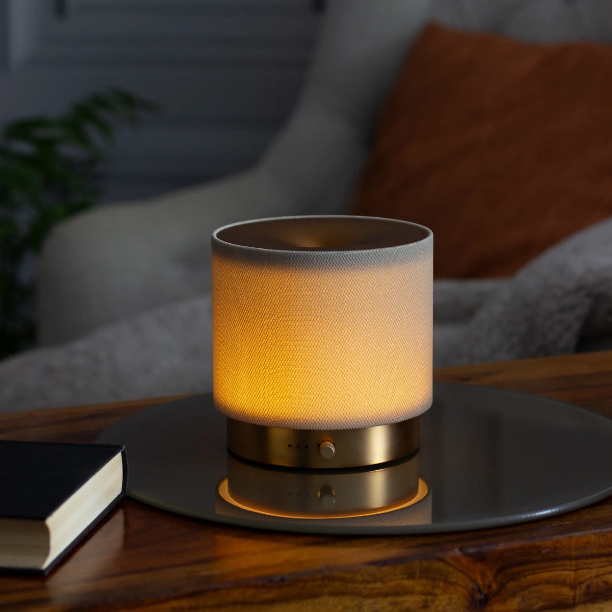 Detailed close-up of artisanal stone-coloured textured fabric and brushed gold rim on the Mira USB Aroma Diffuser by Hideaway Home Fragrances