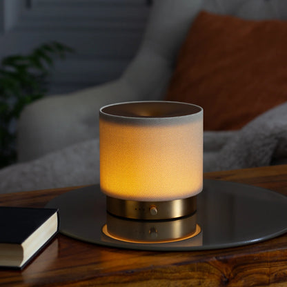 Detailed close-up of artisanal stone-coloured textured fabric and brushed gold rim on the Mira USB Aroma Diffuser by Hideaway Home Fragrances