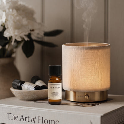 Mira USB Aroma Diffuser featuring stone-hued textured fabric wrap and brushed gold accents by Hideaway Home Fragrances on neutral studio background