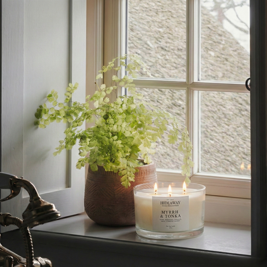 Myrrh and Tonka 3-wick luxury candle filling a living room with warm, opulent fragrance for a sensual home atmosphere