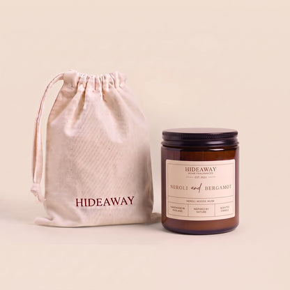 Uplifting neroli and bergamot aromatic candle in an amber glass jar creating a vibrant floral atmosphere from Hideaway Home Fragrances