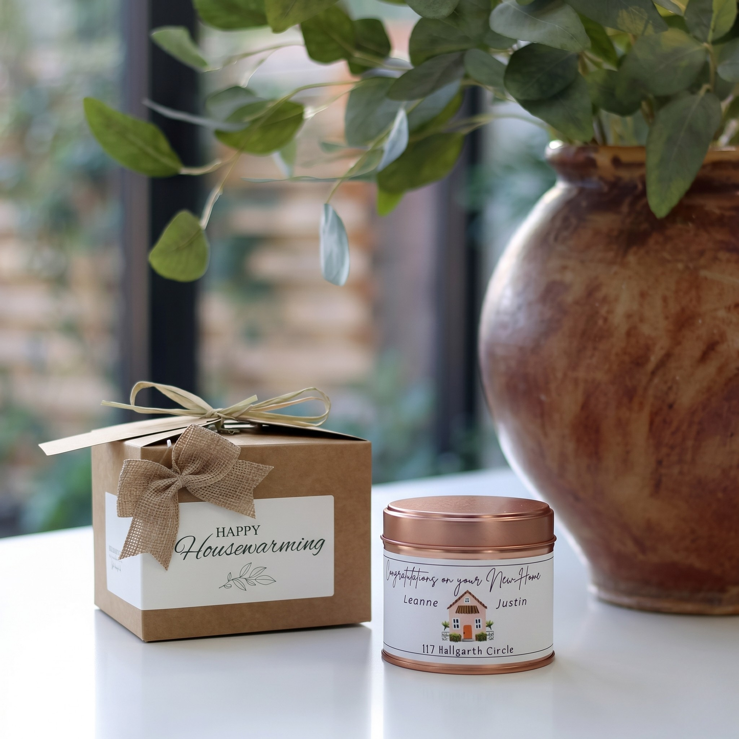 Custom housewarming care package gift box featuring a personalized new homeowner congratulations candle and matching home fragrance diffuser by Hideaway Home Fragrances.