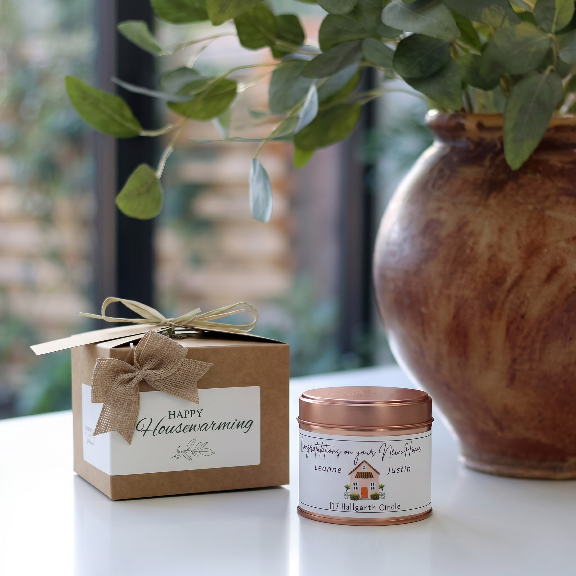 Custom housewarming care package gift box featuring a personalized new homeowner congratulations candle and matching home fragrance diffuser by Hideaway Home Fragrances.
