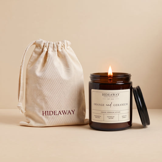 Orange and geranium amber glass candle with uplifting citrus floral scent by Hideaway Home Fragrances