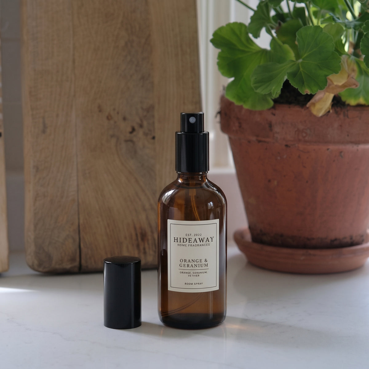 Fragrance notes graphic for Hideaway Home Fragrances orange and geranium room spray featuring sweet orange, floral geranium, and earthy vetiver.