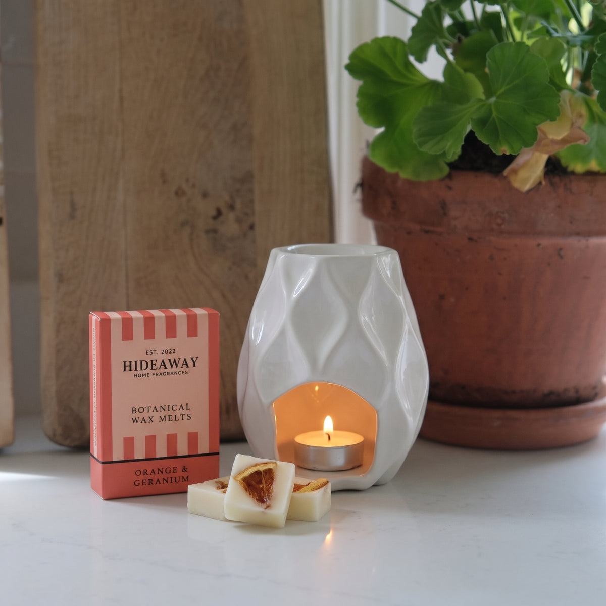 Artisan orange and geranium botanical wax melt snap bar by Hideaway Home Fragrances topped with dried floral and citrus botanicals