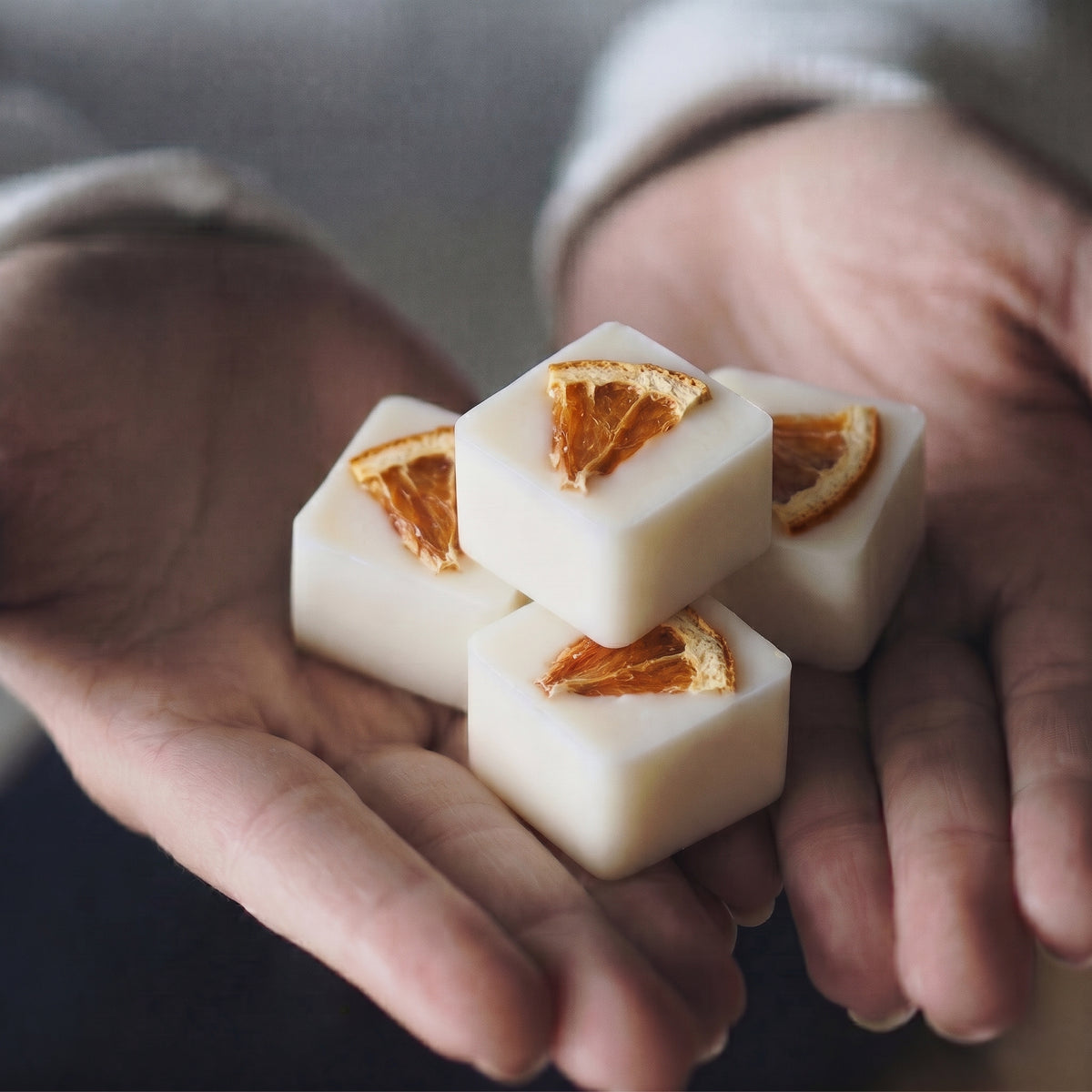 Close up of Hideaway Home Fragrances orange and geranium botanical wax melts displaying textured soy wax embedded with real botanicals