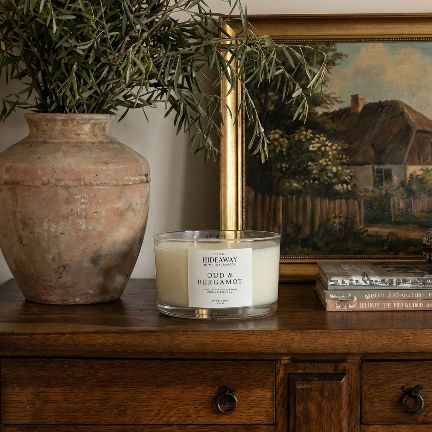 Sophisticated Oud & Bergamot three-wick candle filling a living space with rich smoky fragrance for refined home ambience