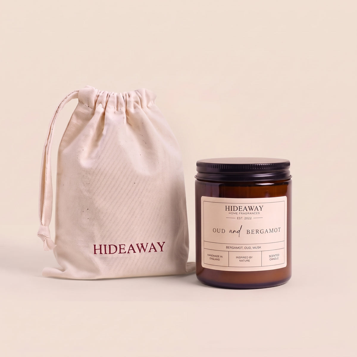Sophisticated oud and bergamot aromatic candle in an amber glass jar creating a warm cozy atmosphere from Hideaway Home Fragrances